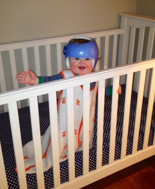 A picture of Will standing up in his crib